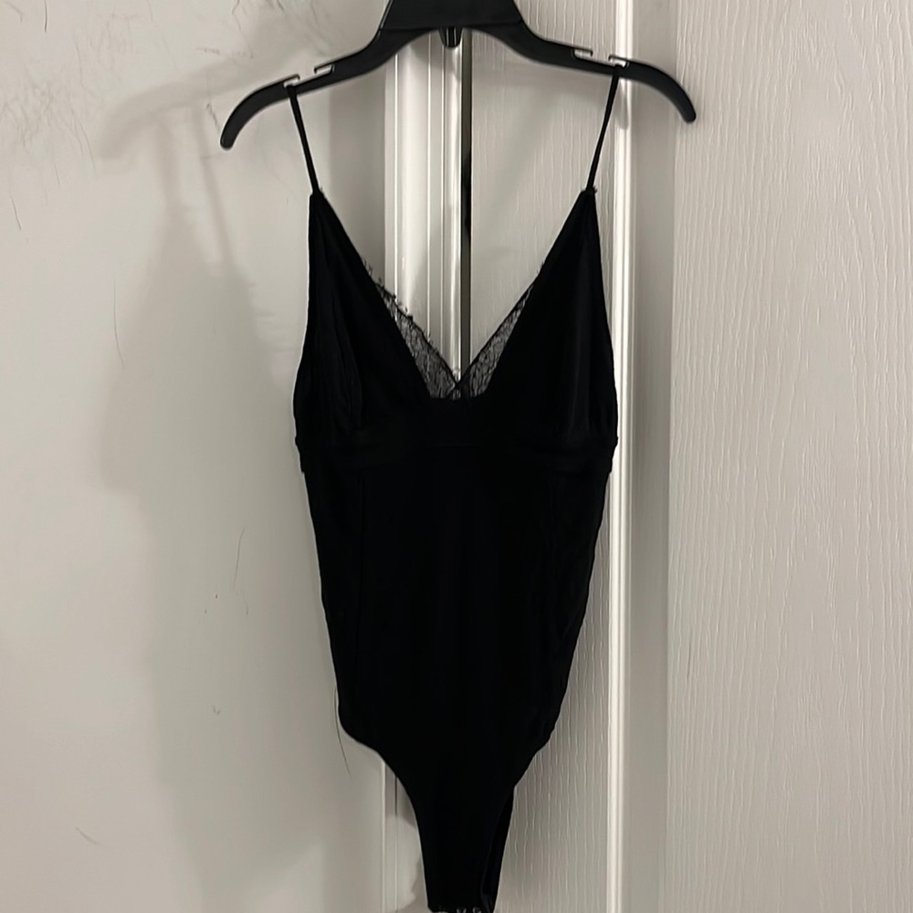 Free people bodysuit with lace. Black /adjustable straps size XS